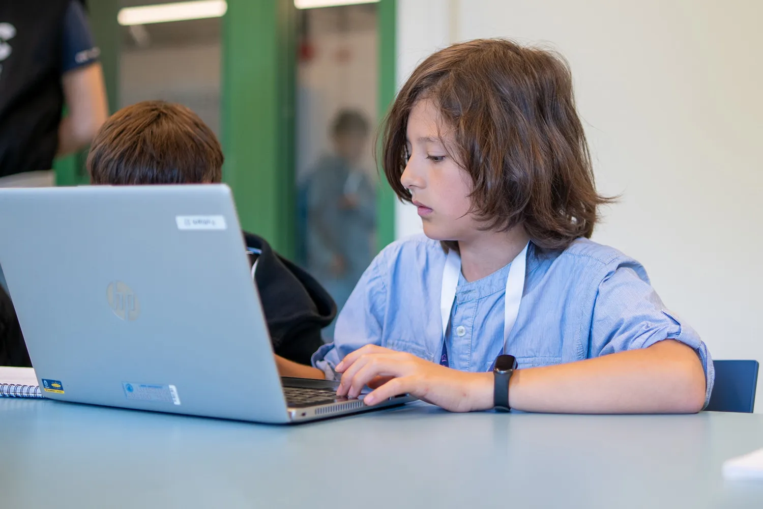 Mellanstadieelev skriver på sin skoldator 